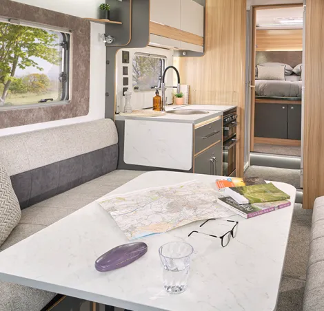 Twin sofa lounge looking towards the kitchen and island bed in the new Adamo XL-I from Bailey