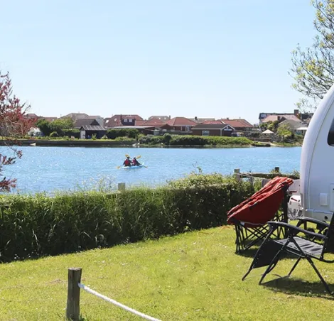 fishing lake, with a nearby caravan