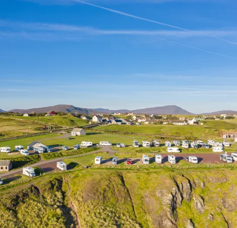 Drone shoot over coastal campsite at sunny autumnal morning in the most Northwest Highlands of Scotland - NC500 Route