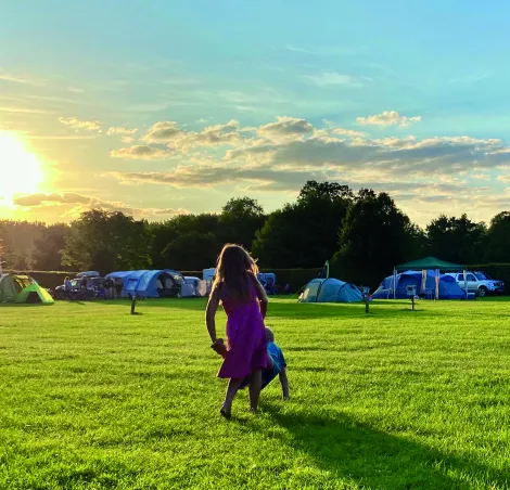 The sun-sets above a family-friendly campsite 