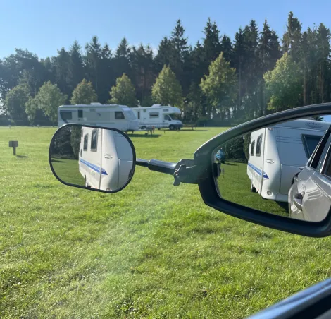 Typical driver view of towing caravan trailer set with safety mirror
