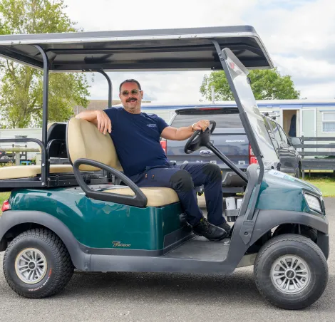 Danny Dyer on a golf cart at a Kent seaside caravan park