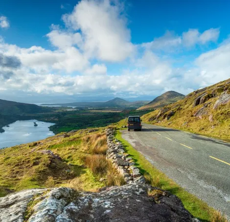 image of a campervan driving down a scenic route
