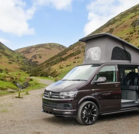 image of a black caravan parked up