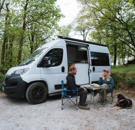 Couple outside of their Campervan