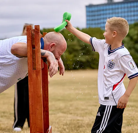 Youngsters enjoyed giving grown-ups a soaking in the stocks during the “Battle of the Holiday Homes” event in aid of HEY Children’s University