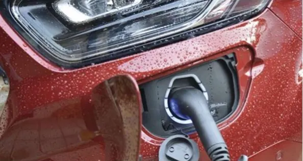 An electric campervan being charged