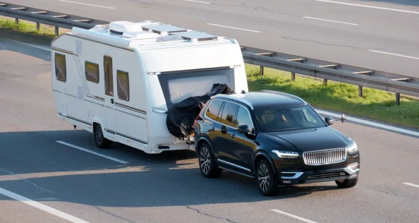 SUV Towing Large Home Trailer on Highway for Road Trip