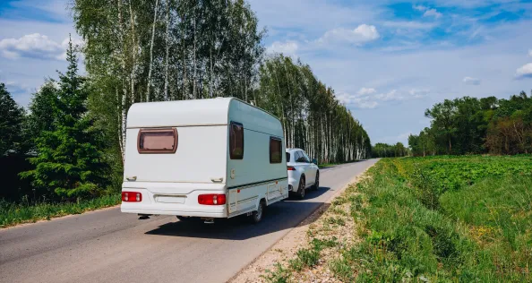 Caravan being towed to campsite on family holiday