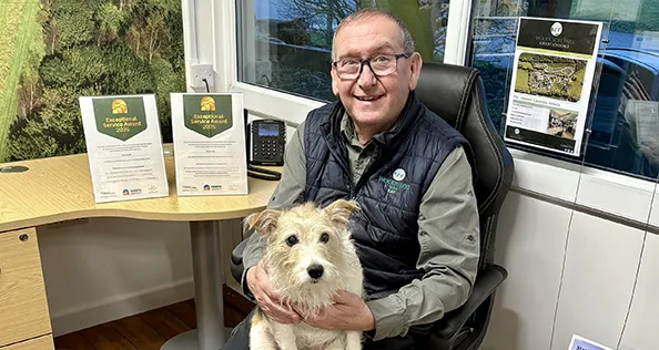 Skye and Ray proudly show their exceptional service awards